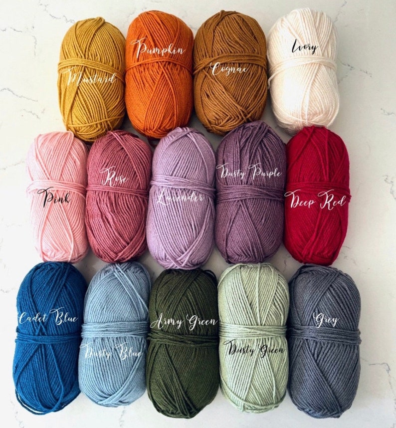 May include: A collection of 15 yarn balls in various colors, including pink, lavender, dusty purple, deep red, army green, dusty green, grey, ivory, mustard, pumpkin, cognac, rose, cadet blue, and dusty blue.