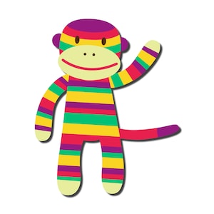 May include: A colorful striped monkey toy with a purple head, green, yellow, red, and purple stripes. The monkey is smiling and has its arm raised in the air.