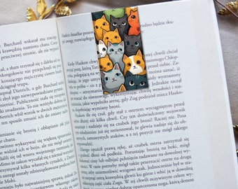 May include: A colorful bookmark featuring a group of cats with different colored fur and patterns. The cats are arranged in a vertical stack, with the top cat looking directly at the viewer. The bookmark is made of durable, high-quality material and is perfect for marking your place in a book.