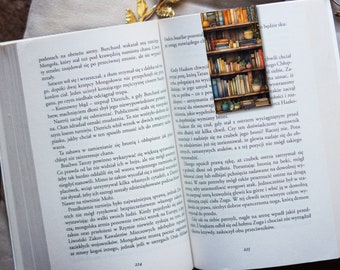 May include: A watercolor painting of a bookshelf filled with books. The bookshelf has three shelves and is painted in a light brown color. The books are painted in various colors, including red, blue, green, and yellow. There are also a few plants on the shelves.