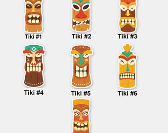 May include: Seven colorful tiki mask stickers with white borders. Each sticker features a different tiki mask with unique facial expressions and details. The stickers are labeled with numbers 1 through 7.