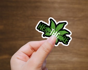 May include: A green marijuana leaf sticker with the text "Healthcare" written in white on a black background.