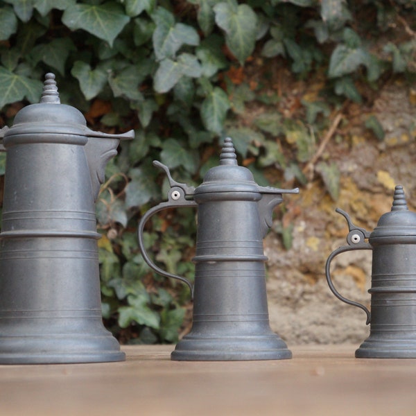 Set of three authentic French zinc beer jugs