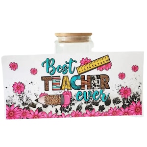 May include: A glass jar with a bamboo lid, wrapped with a white label. The label features the text "Best Teacher Ever" in turquoise and brown, with a pencil, ruler, and pink floral accents.