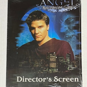 May include: A black and white director's screen for the Angel Roleplaying Game. The screen features a photo of the main character, Angel, in front of a cityscape. The text "Angel Roleplaying Game" is at the top of the screen and "Director's Screen" is at the bottom.