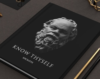May include: A black hardcover journal with a white image of the Greek philosopher Socrates and the text "KNOW THYSELF SOCRATES".