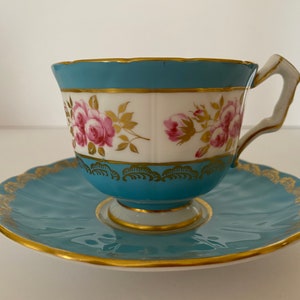 Aynsley 2911 Teacup and Saucer Branch Handle Crocus Pink Roses Blue Bands Gold Feathers Footed Hand Painted Fine Bone China