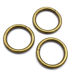 May include: Three gold-toned metal rings, each with a circular shape and a smooth finish.