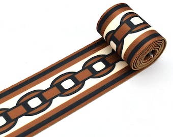 May include: Brown and black striped ribbon with a white chain link pattern.
