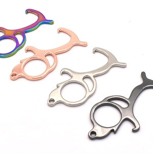 May include: Four door openers in different colors: iridescent, rose gold, silver, and black. Each opener has a hook, a loop, and a bottle opener.