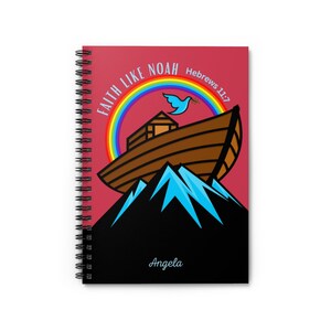May include: A spiral bound notebook with a red cover featuring a cartoon illustration of Noah's Ark on top of a mountain with a rainbow and a dove. The text "Faith Like Noah Hebrews 11:7" is printed on the cover. The name "Angela" is printed at the bottom of the cover.