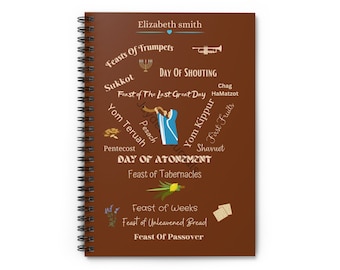 May include: A brown spiral notebook with a colorful illustration of Jewish holidays and their names. The notebook has the name "Elizabeth smith" at the top.