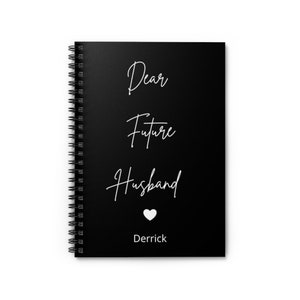 May include: Black spiral notebook with white text that reads "Dear Future Husband Derrick" with a white heart symbol.