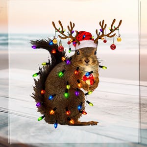 May include: A brown squirrel wearing a Santa hat and reindeer antlers, wrapped in colourful Christmas lights. The squirrel holds a small gift against a beach scene.