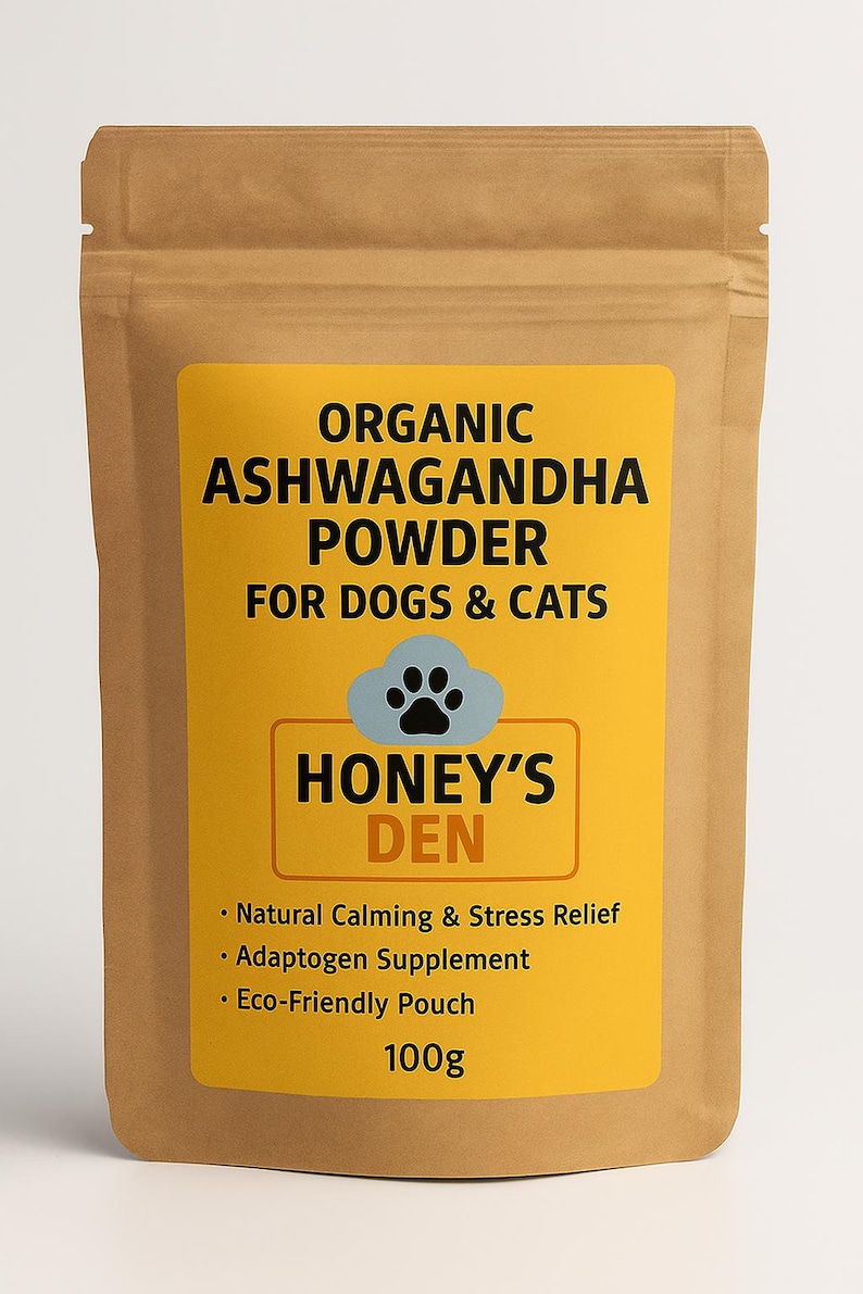 May include: A brown pouch with a yellow label. The label reads "ORGANIC ASHWAGANDHA POWDER FOR DOGS & CATS" and "HONEY'S DEN" with a paw print. The pouch contains 100g of product, with details about its calming and stress relief properties.