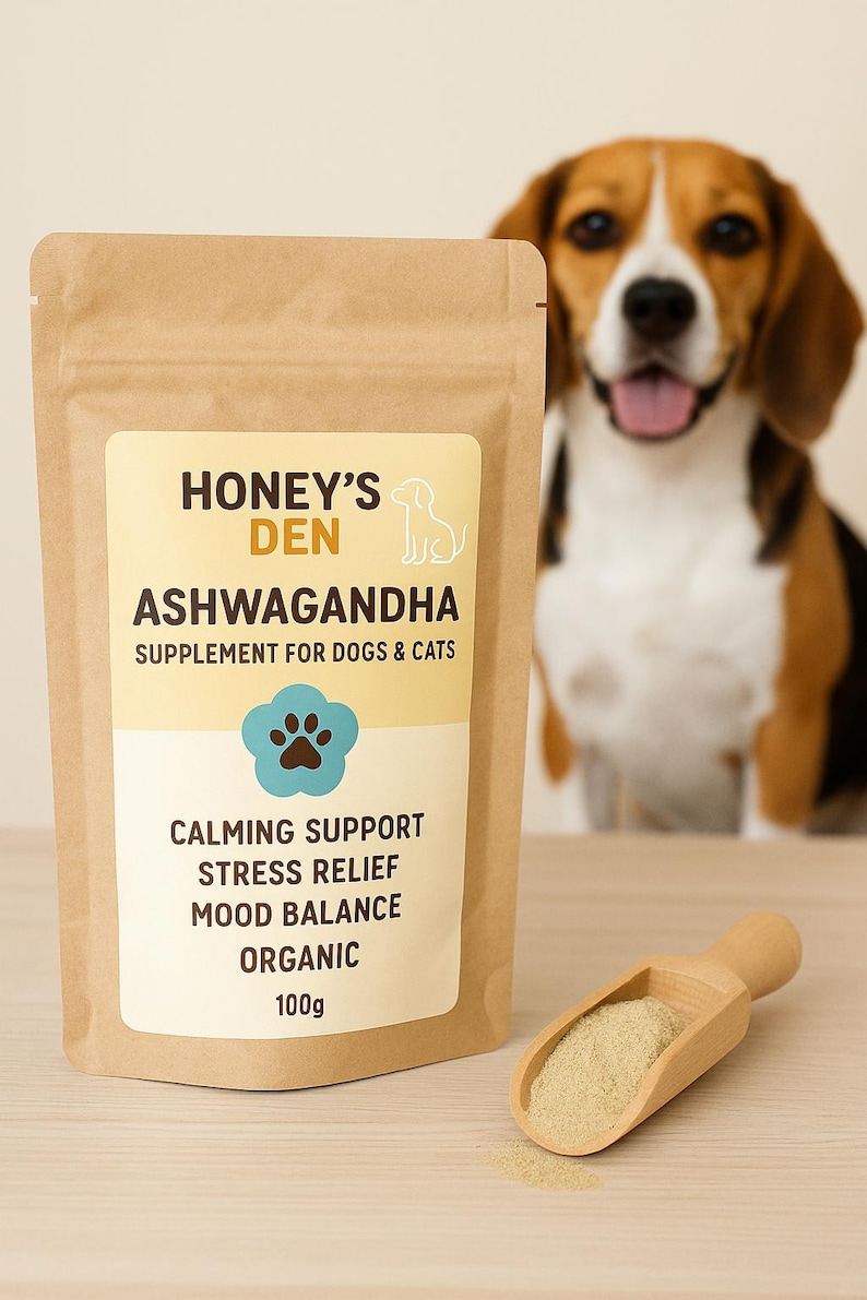 May include: A brown paper bag of Honey's Den Ashwagandha supplement for dogs and cats. The label includes the text "Calming Support, Stress Relief, Mood Balance, Organic, 100g". A wooden scoop holds the supplement, and a dog is in the background.