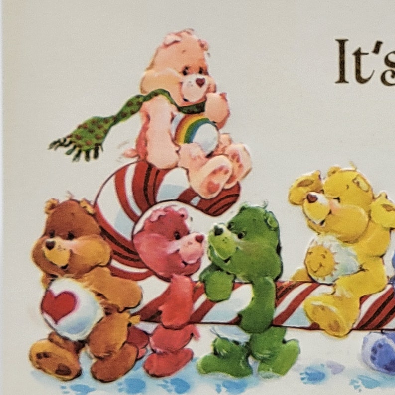 May include: A vibrant illustration of Care Bears in various colours, including brown, pink, green, and yellow. One bear wears a green scarf and holds a rainbow. The bears are arranged on a candy cane, creating a cheerful scene.