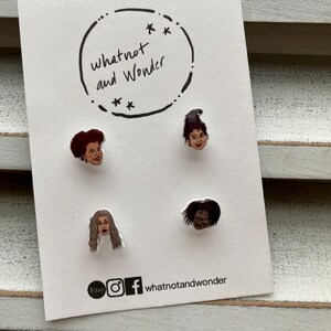 May include: A white card with a black circle containing the text "whatnot and Wonder" and four small, colourful, round pins featuring characters from the movie Hocus Pocus. The card also includes the text "Etsy" and social media icons for Instagram and Facebook.