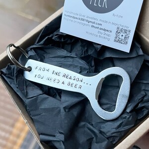 May include: Silver bottle opener keychain with the text "From the reason... you need a beer".