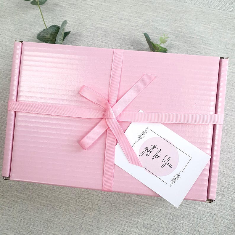 May include: A pink gift box with a white ribbon and a gift tag that says "gift for you".