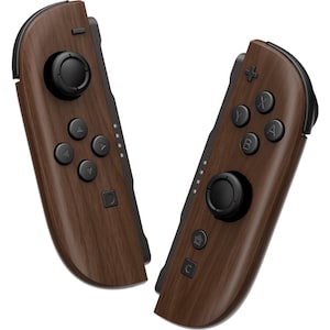 May include: A pair of video game controllers featuring a dark brown wood grain pattern. The left controller has a black analog stick, a directional pad, and a square button. The right controller has a black analog stick, A, B, X, Y buttons, a home button, and a capture button.