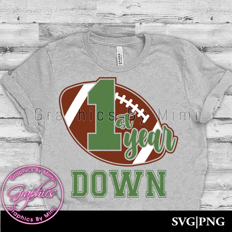 May include: A grey t-shirt with a green number one and the words "1st year down" on a brown and white football graphic.