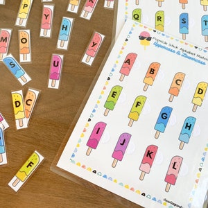 May include: A printable alphabet matching game featuring popsicle stick graphics. The game includes uppercase and lowercase letters. The game is designed for children to learn the alphabet.