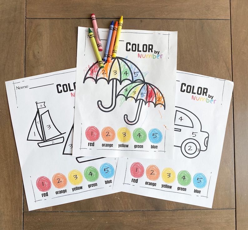 May include: Three printable coloring pages with the text "Color by Number" at the top. The pages feature a sailboat, an umbrella, and a car. Each page has a color key with five circles, labeled with numbers and colors: red, orange, yellow, green, and blue.