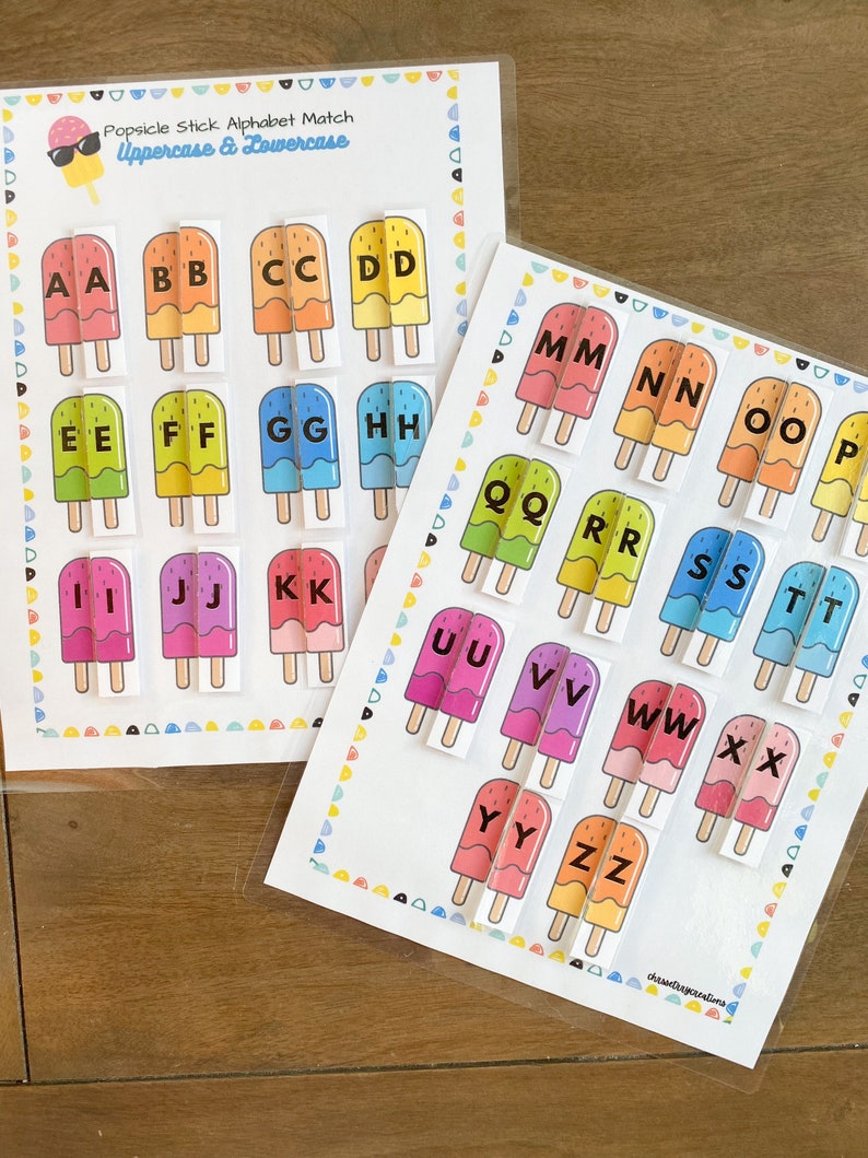 May include: Two printable worksheets for a popsicle stick alphabet match game. The worksheets feature colorful popsicle stick illustrations with uppercase and lowercase letters. The text on the worksheets reads "Popsicle Stick Alphabet Match Uppercase & Lowercase".