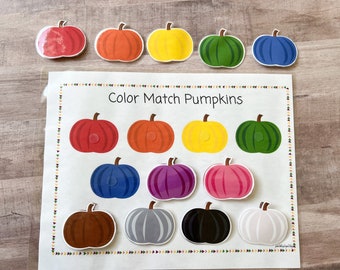 May include: A printable educational game for kids featuring a color matching activity with pumpkins. The game includes 10 colorful pumpkins with different colors, including red, orange, yellow, green, blue, purple, brown, gray, black, and white. The game is titled "Color Match Pumpkins".