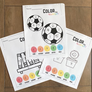May include: Three printable coloring pages with the text "Color by Number". Each page features a different image: a soccer ball, a bookshelf, and a flower in a pot. The pages include a color key with five colors: red, orange, yellow, green, and blue.