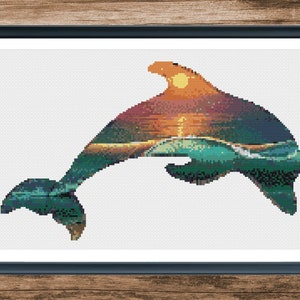 May include: A cross-stitch pattern featuring a dolphin silhouette with a sunset and ocean waves inside. The dolphin is jumping out of the water with its tail in the air. The sunset is a vibrant orange and yellow, with a blue sky above. The ocean waves are a deep blue and green.