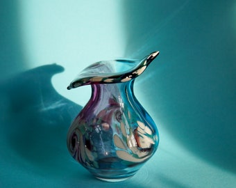 Small vintage vase made of blue-tinted glass with colourful details