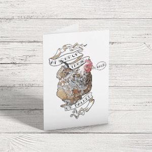 May include: A folded greeting card featuring a watercolor illustration of a chicken with a speech bubble that says "Belk". The chicken is surrounded by banners that read "Eat of these, We Ballet". The card is white with a watercolor design.