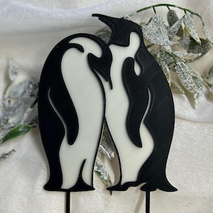 Elegant black and white penguin silhouette cake topper, featuring two penguins as a symbol of love and loyalty. Suitable for weddings, anniversaries, and romantic celebrations. Made with biodegradable PLA plastic.