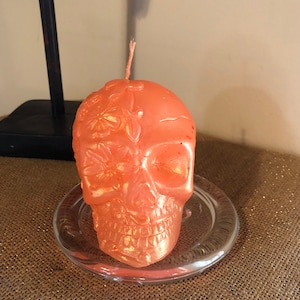 Metallic orange skull candle with pumpkin spice scent