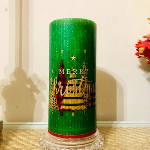 6 inch tall Merry Christmas ribbed pillar candle with a woodsy fall fragrance