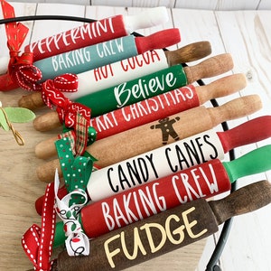 May include: A set of three ceramic mugs with a speckled, matte finish. The mugs are in shades of cream, light gray, and dark gray. Each mug has a simple, minimalist design and a rounded handle.