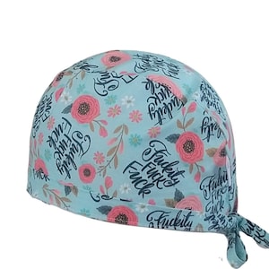 May include: A light blue scrub hat with a floral pattern and the text "F*ckity F*ck F*ck" repeated throughout.