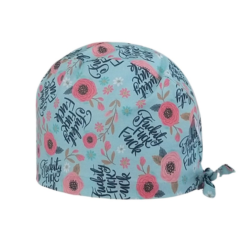 May include: A light blue scrub hat with a floral pattern and the text "F*ckity F*ck F*ck" repeated throughout.