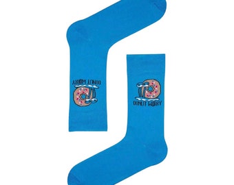 May include: A pair of blue socks with a donut graphic and the text "Donut Worry" on one sock and "Donut Judge" on the other sock.