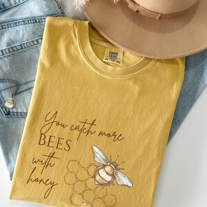 You Catch More Bees With Honey Shirt – Bee Kind Quote Tee, Positive Graphic T-Shirt, Comfort Colors Tee for Bee Lovers, Honey Bee Shirt