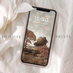 May include: A gold smartphone with a landscape image of a forest scene as the wallpaper. The time is 15:30 and the date is Friday, 10 December.