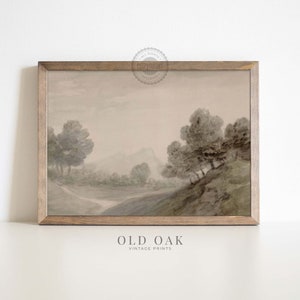May include: A vintage watercolour painting of a misty landscape with trees and a winding path. The painting is framed in a light brown wood frame. The text "OLD OAK VINTAGE PRINTS" is printed below the frame.