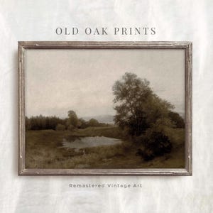 May include: A vintage landscape painting in a brown wooden frame. The painting depicts a lake with trees and a cloudy sky. The painting is titled "Old Oak Prints" and has the text "Remastered Vintage Art" below the frame.