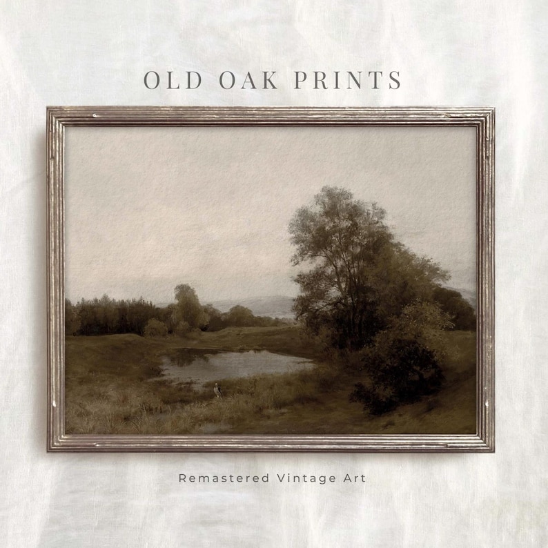 May include: A vintage landscape painting in a brown wooden frame. The painting depicts a lake with trees and a cloudy sky. The painting is titled "Old Oak Prints" and has the text "Remastered Vintage Art" below the frame.