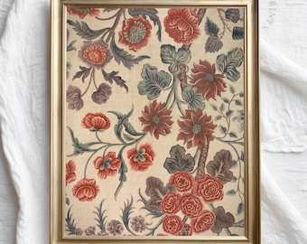 May include: A framed print of a vintage floral pattern with red, pink, and blue flowers on a cream background.