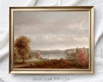 May include: A framed landscape painting depicting a lake scene with a cloudy sky, trees, and a distant shoreline. The painting is in a gold frame.