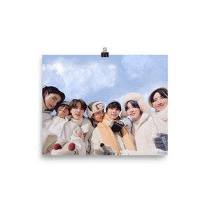 May include: Seven people wearing winter clothing, including hats and scarves, are smiling and looking at the camera. The background is a blue sky with white clouds.