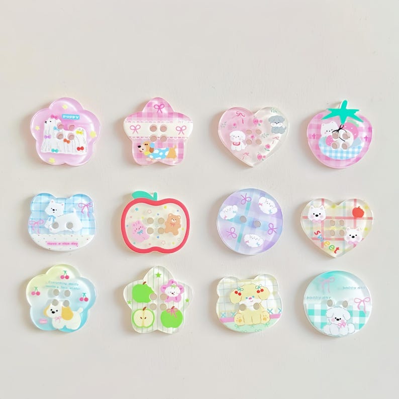 May include: A collection of twelve decorative buttons in various shapes, including flowers, hearts, and apples. Each button features a cute cartoon animal design in pastel colors, with a glossy finish. The buttons are ideal for crafts and sewing projects.